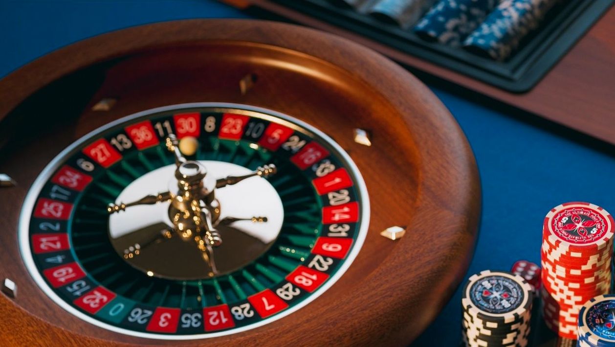 Corporate guests socializing around a roulette table